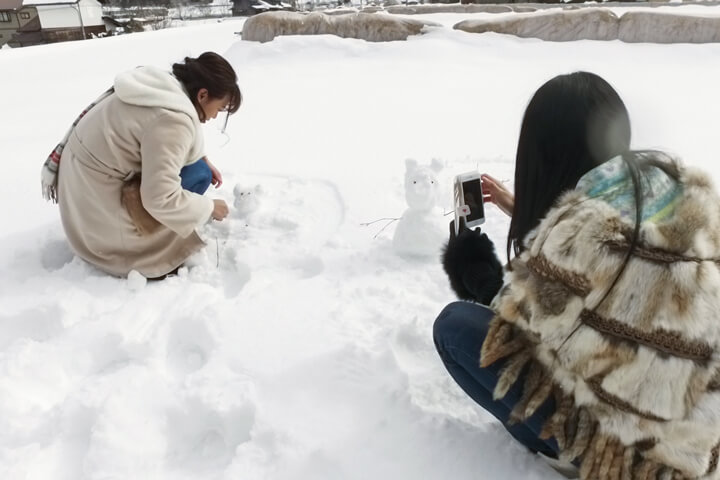 Girls build snowmen